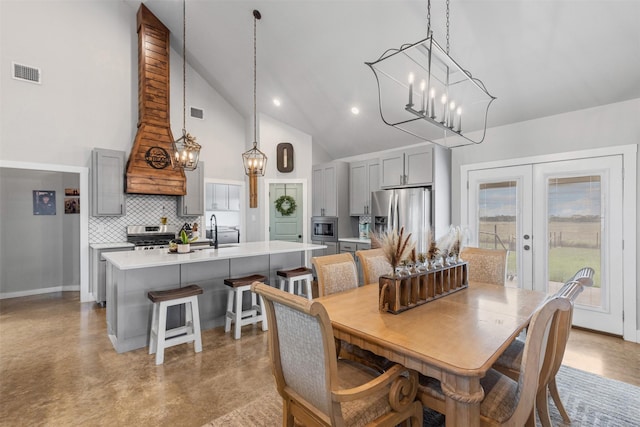 243 Fm 203, Walnut Springs, TX 76690 - dining space featuring high vaulted ceiling, french doors, concrete floors, a chandelier, and baseboards