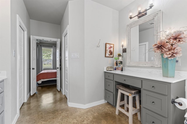 243 Fm 203, Walnut Springs, TX 76690 - ensuite bathroom with vanity, finished concrete flooring, and baseboards