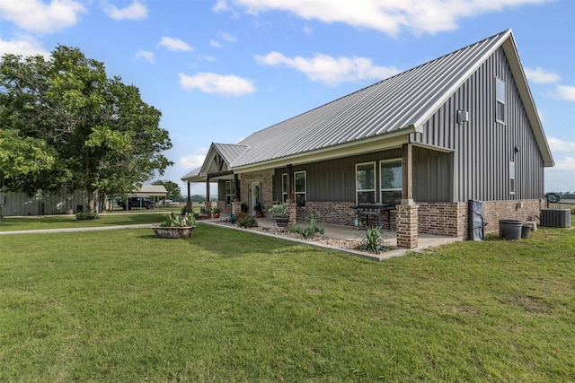243 Fm 203, Walnut Springs, TX 76690 - view of front of home with brick siding, central AC, a front lawn, and a patio area