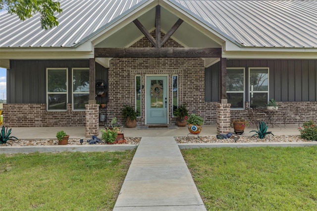 243 Fm 203, Walnut Springs, TX 76690 - entrance to property featuring brick siding, a porch, board and batten siding, and a lawn