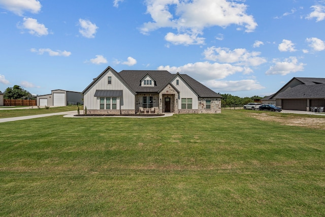 381 Oak Meadow Ln, Weatherford, TX 76085 - view of front facade with board and batten siding, a front yard, and a detached garage