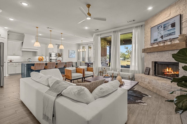 381 Oak Meadow Ln, Weatherford, TX 76085 - living room featuring recessed lighting, light wood finished floors, a fireplace, and a ceiling fan