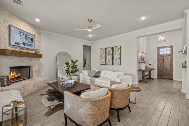 381 Oak Meadow Ln, Weatherford, TX 76085 - living room with light wood-style floors, baseboards, a fireplace, a ceiling fan, and crown molding