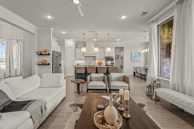 381 Oak Meadow Ln, Weatherford, TX 76085 - living area featuring recessed lighting, light wood finished floors, ornamental molding, and baseboards