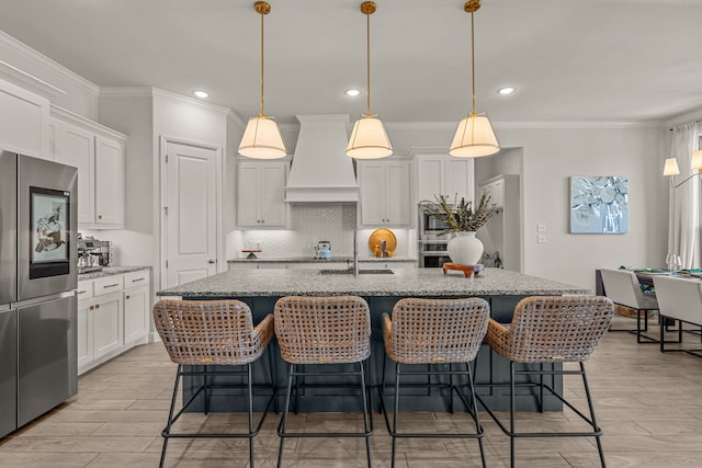 381 Oak Meadow Ln, Weatherford, TX 76085 - kitchen featuring appliances with stainless steel finishes, custom exhaust hood, a sink, decorative backsplash, and white cabinetry