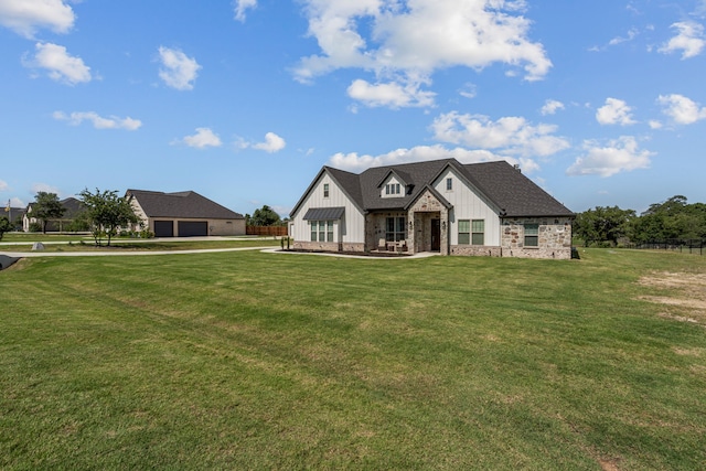 381 Oak Meadow Ln, Weatherford, TX 76085 - rear view of house with board and batten siding, stone siding, a garage, and a yard
