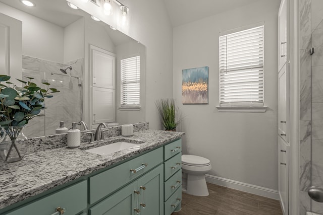 381 Oak Meadow Ln, Weatherford, TX 76085 - bathroom featuring vanity, a marble finish shower, toilet, wood finished floors, and baseboards