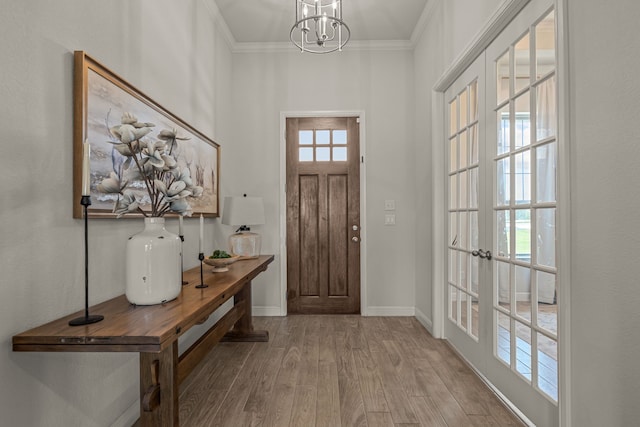 381 Oak Meadow Ln, Weatherford, TX 76085 - foyer with wood finished floors, a chandelier, baseboards, ornamental molding, and french doors