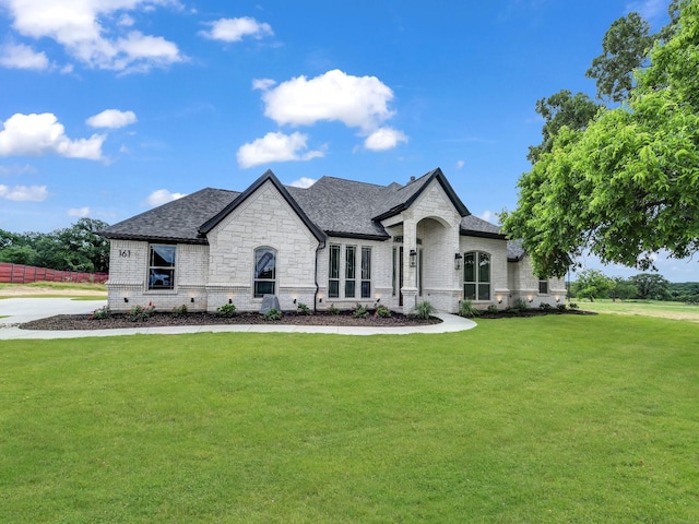 161 Altom Rd, Springtown, TX 76082 - french provincial home with brick siding, a front yard, a shingled roof, and stone siding