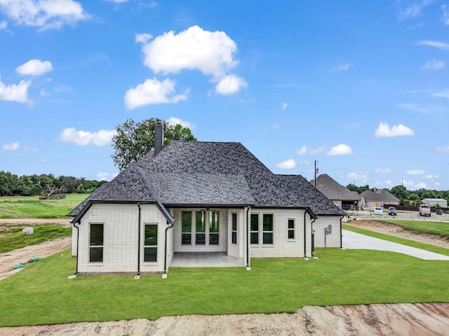 161 Altom Rd, Springtown, TX 76082 - rear view of house with brick siding, roof with shingles, a chimney, and a yard