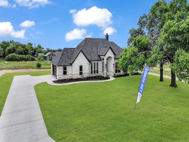 161 Altom Rd, Springtown, TX 76082 - french provincial home with concrete driveway, stone siding, a chimney, and a front yard