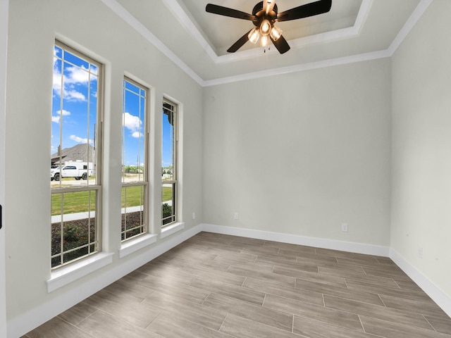 161 Altom Rd, Springtown, TX 76082 - empty room featuring a raised ceiling, ceiling fan, crown molding, baseboards, and wood finished floors