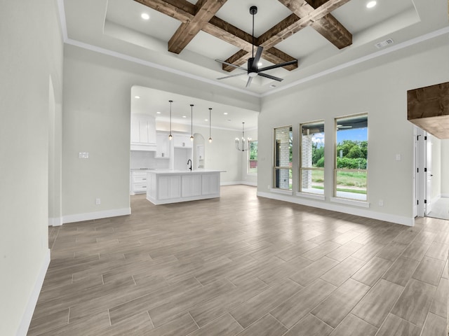 161 Altom Rd, Springtown, TX 76082 - unfurnished living room with baseboards, beamed ceiling, a ceiling fan, coffered ceiling, and light wood-style flooring