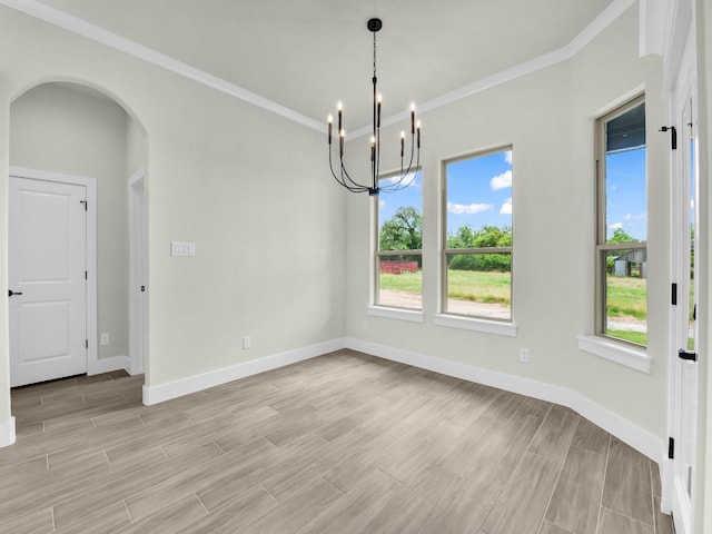 161 Altom Rd, Springtown, TX 76082 - unfurnished dining area featuring light wood-style flooring, a chandelier, crown molding, arched walkways, and baseboards