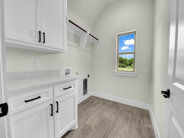 161 Altom Rd, Springtown, TX 76082 - laundry room with hookup for a washing machine, electric dryer hookup, cabinet space, baseboards, and light wood-style flooring