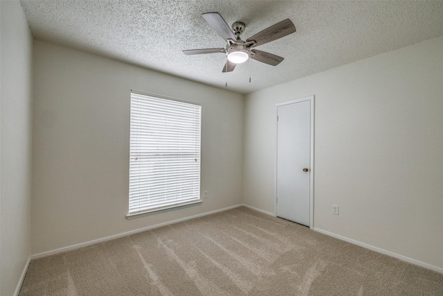 2315 Yale Dr, Arlington, TX 76015 - spare room featuring light carpet, ceiling fan, a textured ceiling, and baseboards