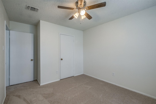 2315 Yale Dr, Arlington, TX 76015 - unfurnished bedroom featuring carpet flooring, a textured ceiling, baseboards, and ceiling fan