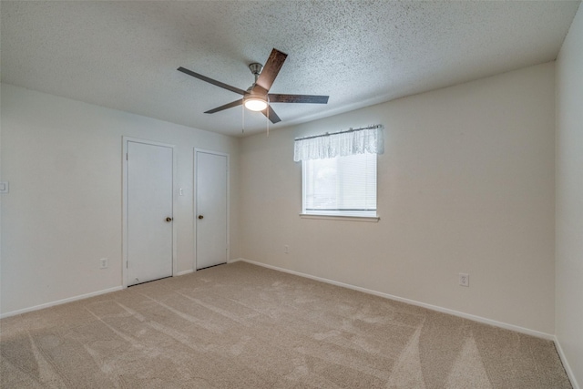 2315 Yale Dr, Arlington, TX 76015 - unfurnished bedroom with light colored carpet, baseboards, a textured ceiling, and ceiling fan