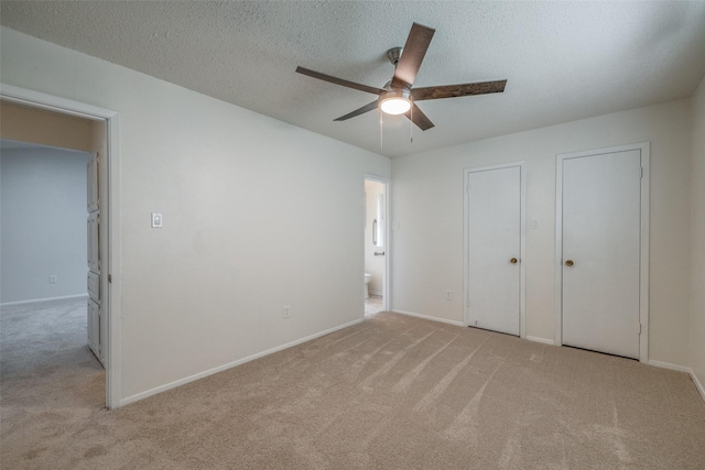 2315 Yale Dr, Arlington, TX 76015 - unfurnished bedroom featuring light carpet, baseboards, connected bathroom, and a textured ceiling