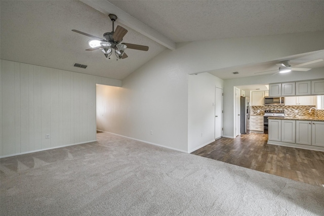2315 Yale Dr, Arlington, TX 76015 - unfurnished living room featuring ceiling fan, dark carpet, and baseboards