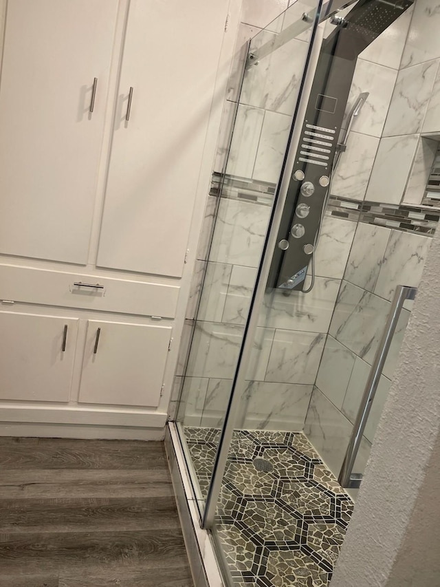1605 Baltimore Dr, Richardson, TX 75081 - bathroom with a stall shower and wood finished floors
