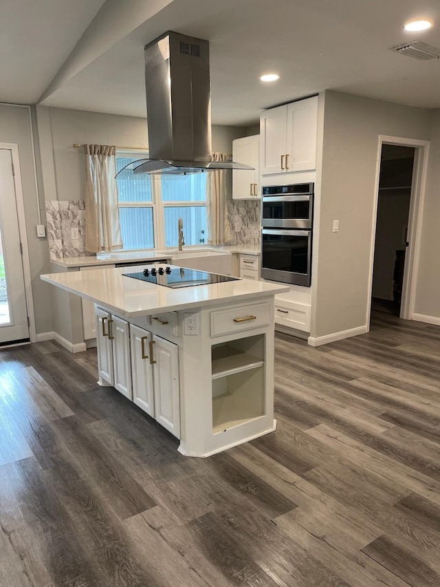 1605 Baltimore Dr, Richardson, TX 75081 - kitchen featuring island exhaust hood, black electric cooktop, double oven, baseboards, and recessed lighting
