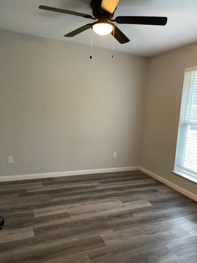 1605 Baltimore Dr, Richardson, TX 75081 - unfurnished room featuring a ceiling fan, dark wood finished floors, and baseboards