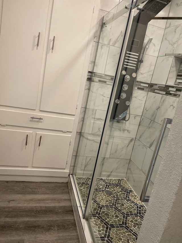 1605 Baltimore Dr, Richardson, TX 75081 - bathroom with a stall shower and wood finished floors
