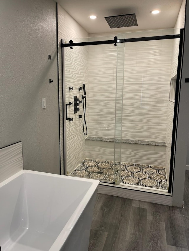 1605 Baltimore Dr, Richardson, TX 75081 - bathroom featuring a freestanding tub, a stall shower, wood finished floors, and recessed lighting