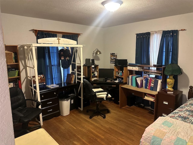 567 N Rice, Hamilton, TX 76531 - bedroom with wood finished floors, an office area, and a textured ceiling