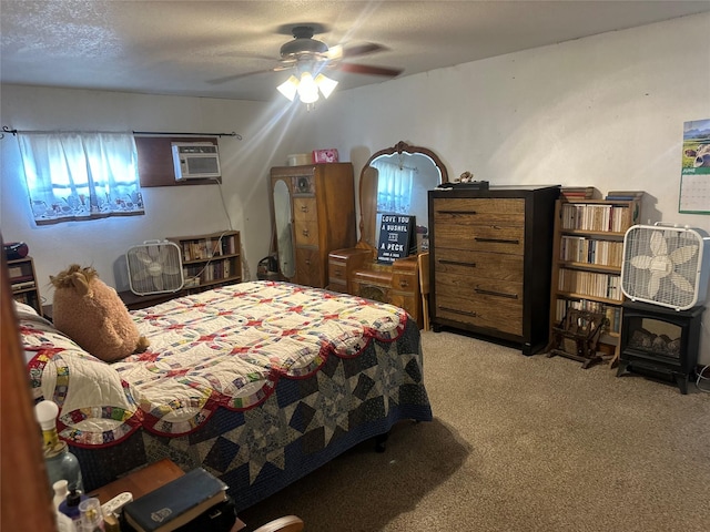 567 N Rice, Hamilton, TX 76531 - carpeted bedroom with a wall unit AC and a ceiling fan