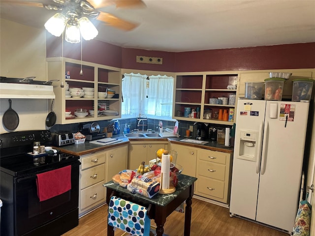567 N Rice, Hamilton, TX 76531 - kitchen with white refrigerator with ice dispenser, black electric range, a sink, open shelves, and under cabinet range hood