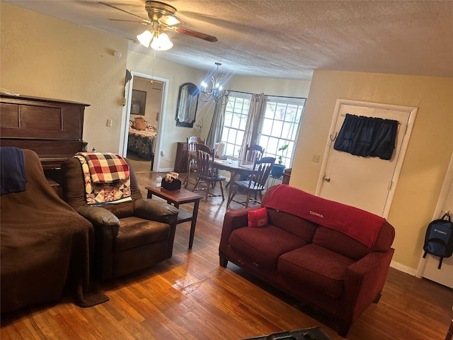 567 N Rice, Hamilton, TX 76531 - living room featuring wood finished floors, ceiling fan, a textured ceiling, and a chandelier