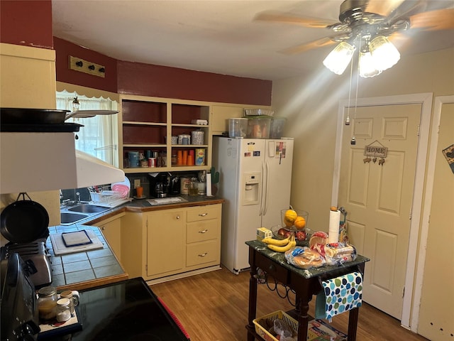 567 N Rice, Hamilton, TX 76531 - kitchen with white fridge with ice dispenser, tile countertops, a ceiling fan, a sink, and light wood-style flooring