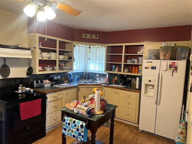 567 N Rice, Hamilton, TX 76531 - kitchen with black range with electric cooktop, white refrigerator with ice dispenser, a sink, under cabinet range hood, and open shelves