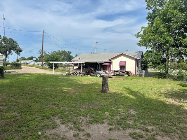 567 N Rice, Hamilton, TX 76531 - rear view of property featuring concrete driveway, a carport, and metal roof