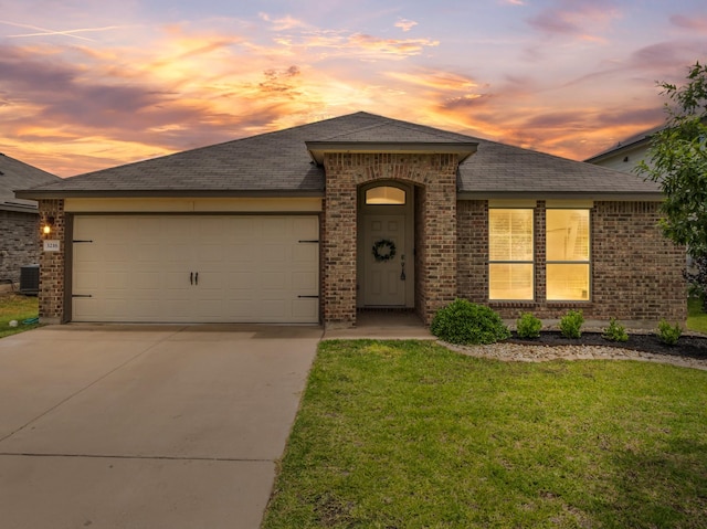 3216 Jackal Dr, Lorena, TX 76655 - view of front of house with brick siding, driveway, an attached garage, a front lawn, and a shingled roof