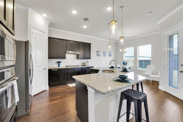 7216 Monet Ln, Grand Prairie, TX 75054 - kitchen with a sink, appliances with stainless steel finishes, a kitchen breakfast bar, an island with sink, and dark wood-style floors