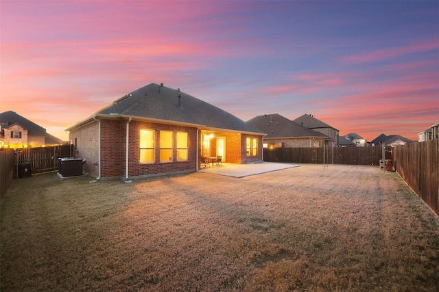 7216 Monet Ln, Grand Prairie, TX 75054 - back of property with central air condition unit, a patio, brick siding, and a shingled roof