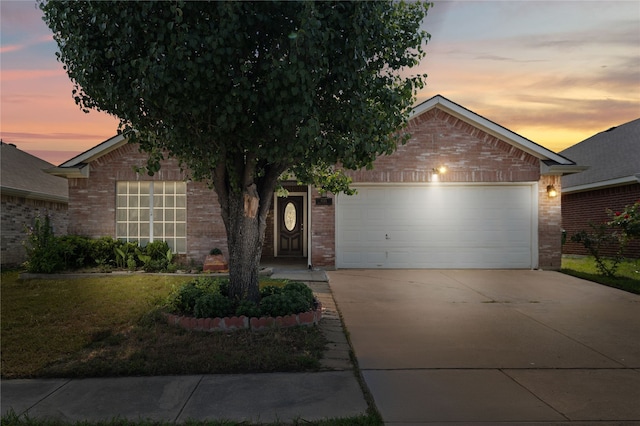 6745 Bear Hollow Ln, Watauga, TX 76137 - view of front of home featuring brick siding, an attached garage, concrete driveway, and a yard