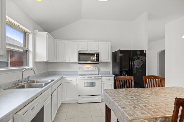 6745 Bear Hollow Ln, Watauga, TX 76137 - kitchen featuring white appliances, a sink, arched walkways, white cabinetry, and vaulted ceiling