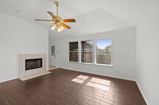 6745 Bear Hollow Ln, Watauga, TX 76137 - unfurnished living room with lofted ceiling, wood finished floors, a tiled fireplace, and baseboards