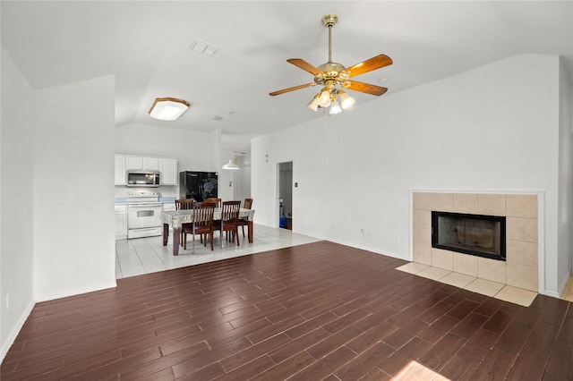 6745 Bear Hollow Ln, Watauga, TX 76137 - living room featuring ceiling fan, vaulted ceiling, light wood-type flooring, and a fireplace