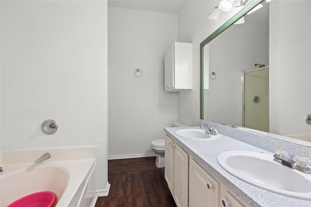 6745 Bear Hollow Ln, Watauga, TX 76137 - full bath featuring a garden tub, baseboards, double vanity, wood finished floors, and a shower with door