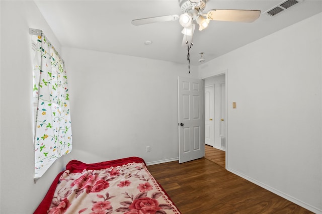 6745 Bear Hollow Ln, Watauga, TX 76137 - bedroom with wood finished floors, baseboards, and a ceiling fan