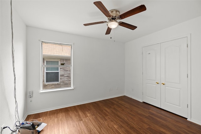 6745 Bear Hollow Ln, Watauga, TX 76137 - unfurnished bedroom featuring dark wood finished floors, baseboards, ceiling fan, and a closet