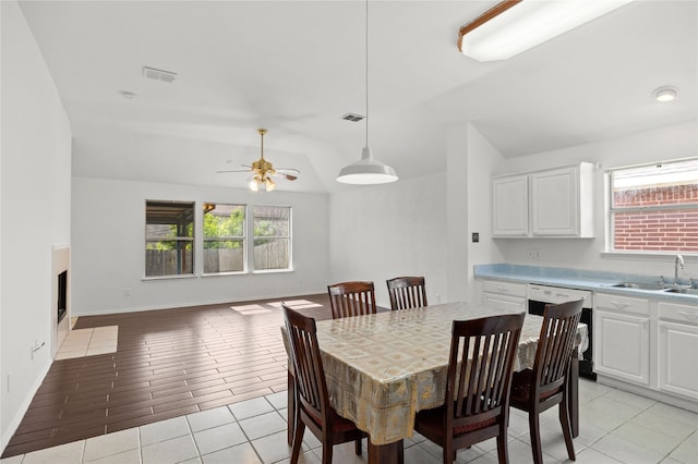 6745 Bear Hollow Ln, Watauga, TX 76137 - dining area featuring vaulted ceiling, ceiling fan, light tile patterned flooring, and baseboards