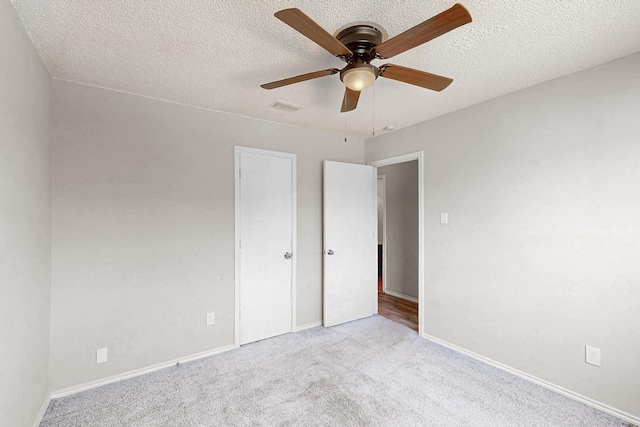 205 Callender Dr, Fort Worth, TX 76108 - unfurnished bedroom with carpet flooring, a textured ceiling, baseboards, and ceiling fan