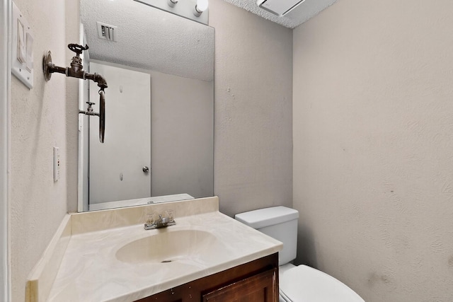 205 Callender Dr, Fort Worth, TX 76108 - bathroom featuring toilet, vanity, a textured ceiling, and a textured wall