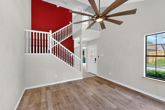 205 Callender Dr, Fort Worth, TX 76108 - unfurnished living room with high vaulted ceiling, a ceiling fan, wood finished floors, baseboards, and stairs